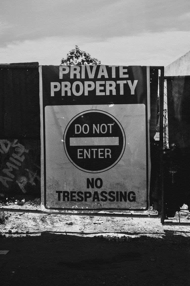 A sign that says private property do not enter trespassing